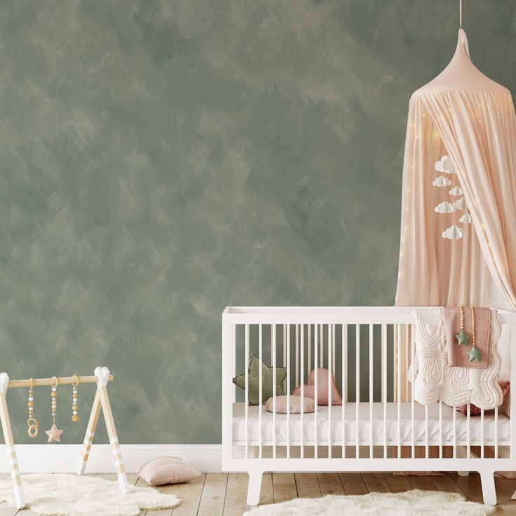 Cozy nursery with a soft green lime-based plaster wall, white crib, and a dreamy canopy with twinkling lights.