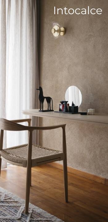 Minimalist vanity space with a textured lime-based painted wall in warm earthy tones.