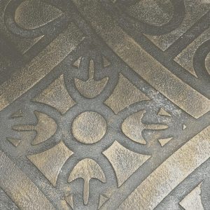 Intricate metallic stencil design featuring symmetrical floral and arrow-like patterns in bronze and black tones.