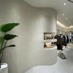 Close-up of Decora A&C TESEO premium lime plaster showcasing a textured, travertine-inspired wall finish in a modern interior.