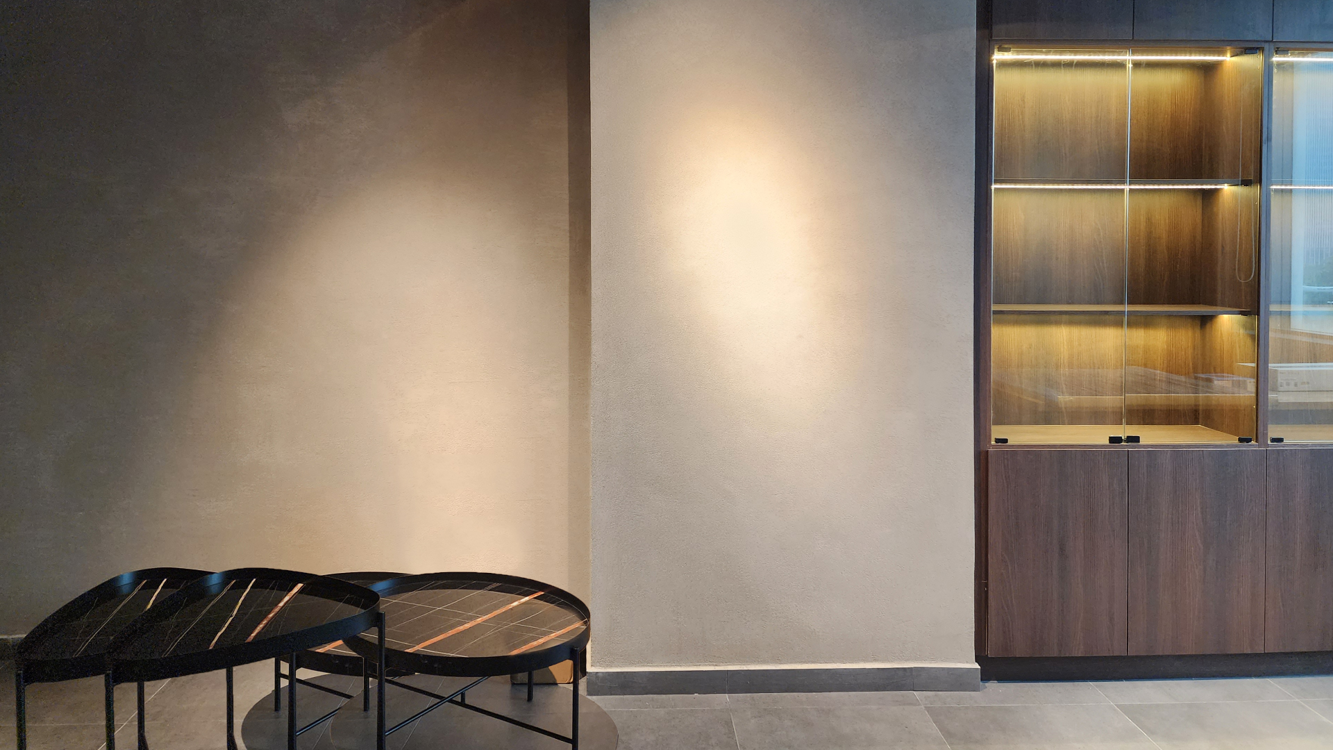 Modern Living Room with Black Coffee Tables and Wooden Storage Cabinet Against Carrara Semi-Gloss Slaked Lime Wall
