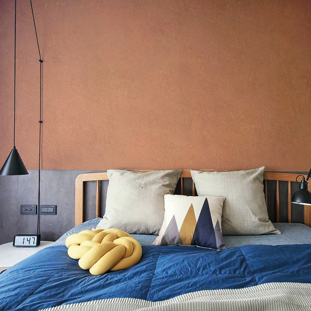 Cozy Bedroom with Blue Bedspread and Geometric Pillows Against Carrara Semi-Gloss Slaked Lime Earth-Toned Wall