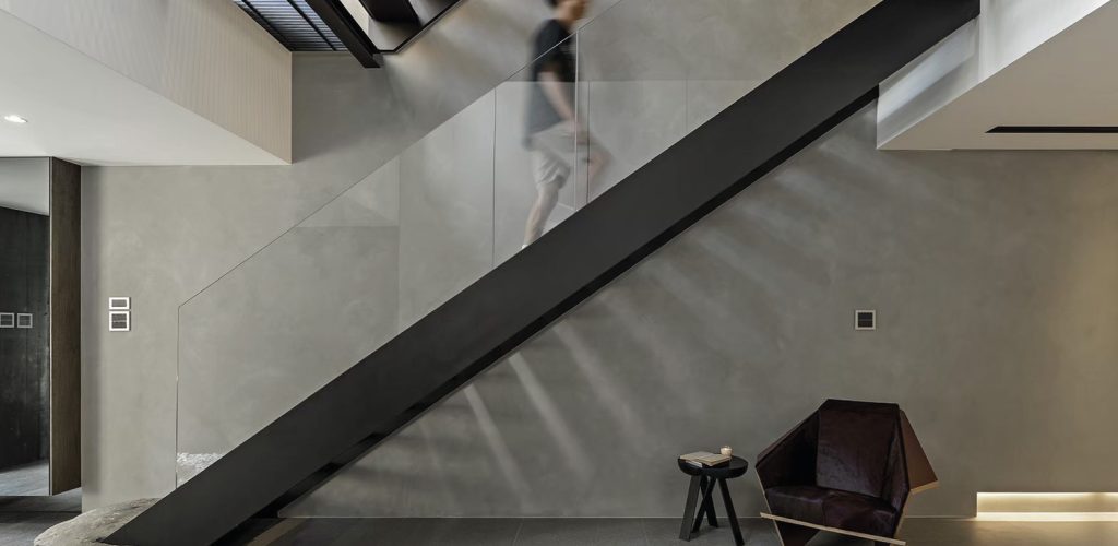 Modern interior with minimalistic stair design and contemporary chair