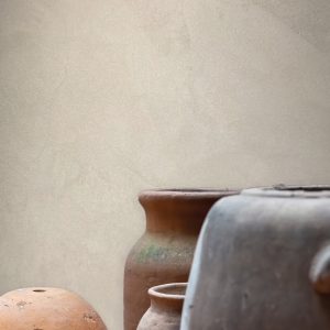 Clay pots in various sizes against a textured beige wall, representing a space ripe for transformation.