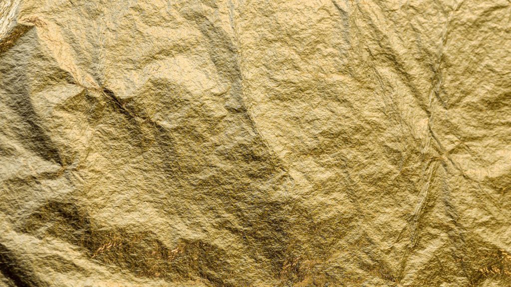 Close-up of crumpled gold foil texture