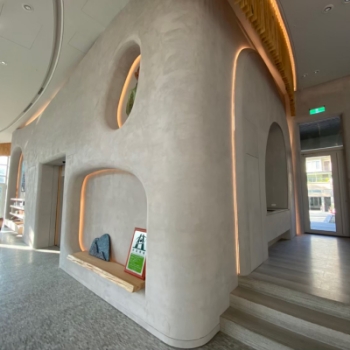 Modern interior featuring lime-based painted walls, showcasing a unique architectural design with luminous accents.