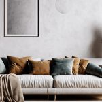 Modern living room with a white sofa, plush pillows, and minimalist decor.