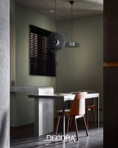 Interior wall finished with Shira lime plaster by Decora, featuring a soft matte texture and subtle natural pattern in a minimalist dining space.