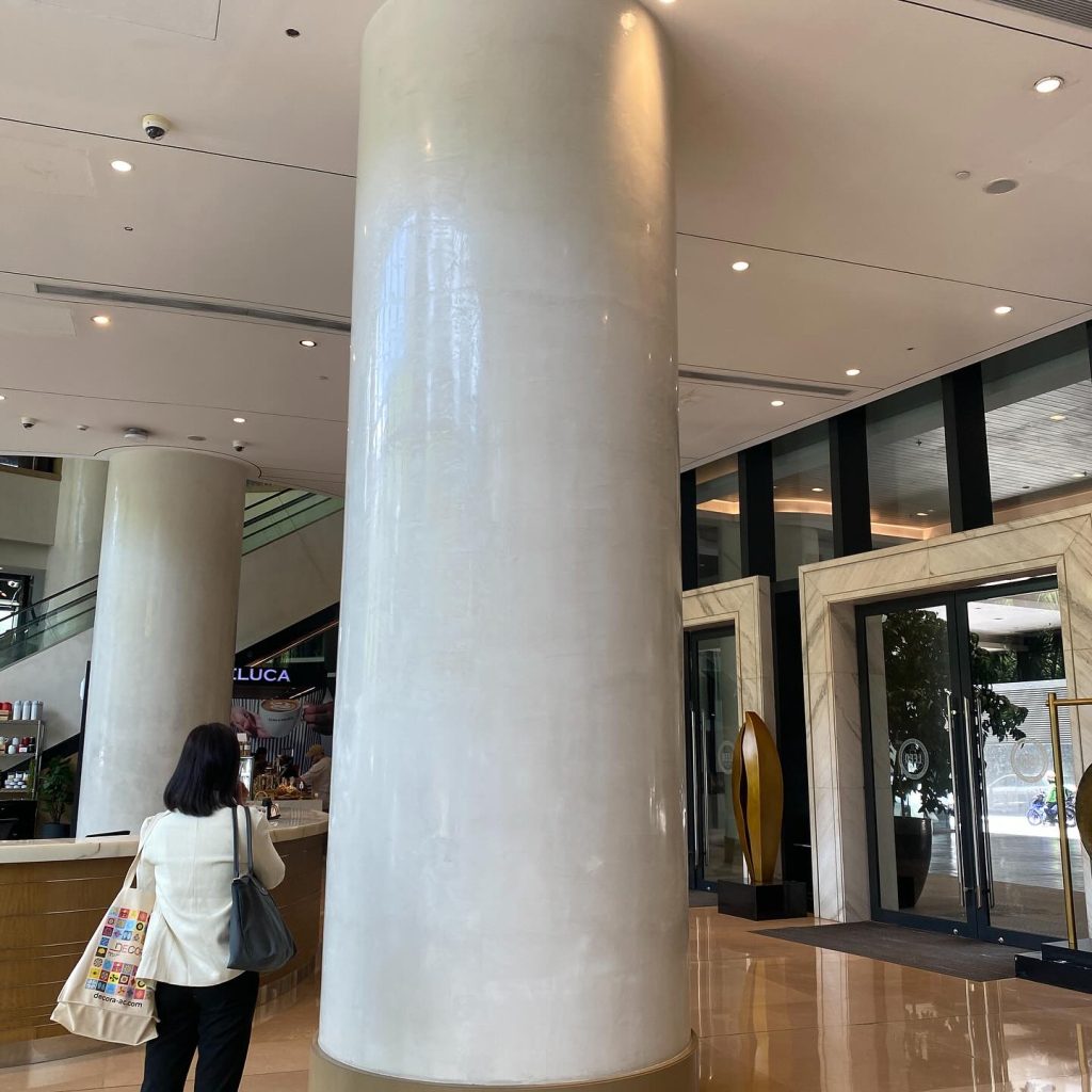 Column finished with DECORA's Ispegu high-gloss lime plaster at Ore Central Tower, BGC Taguig, showcasing a marble-like texture.