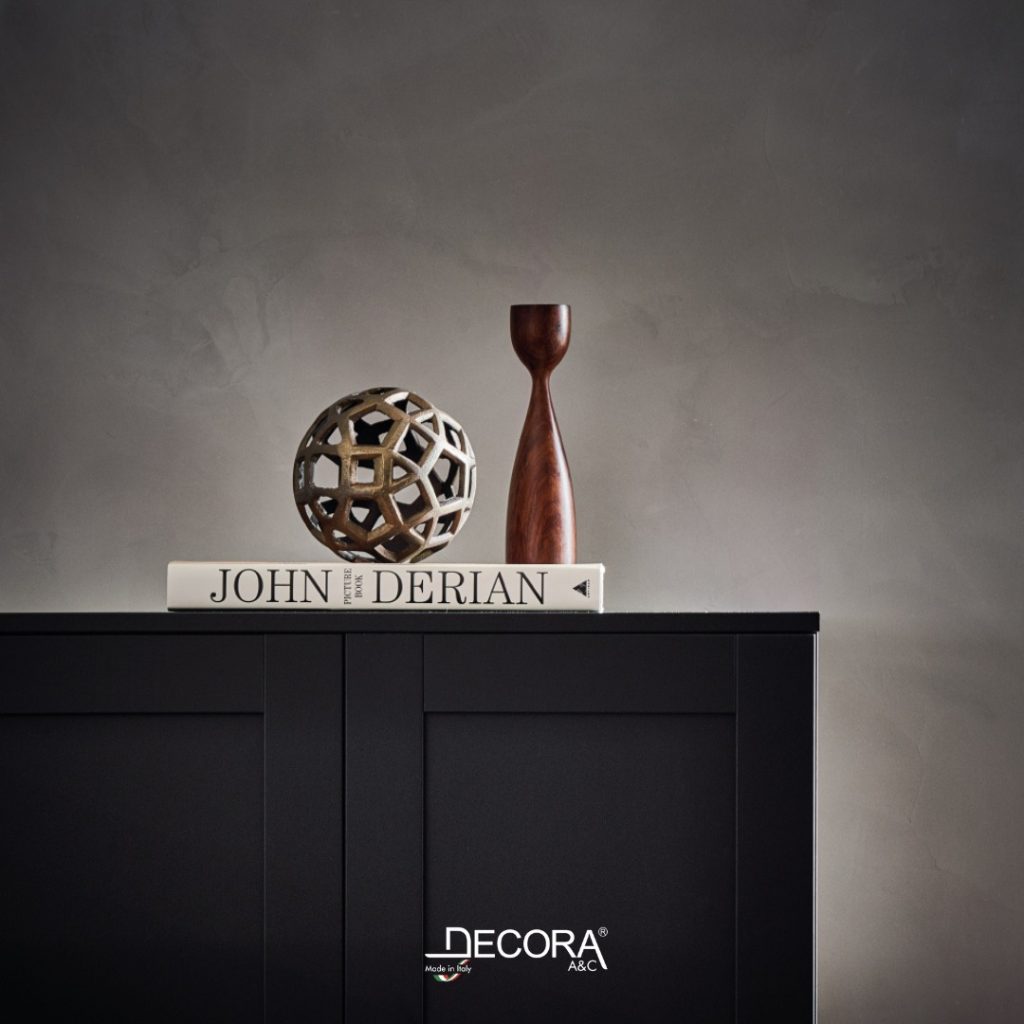 Styled black cabinet against a Tatto slaked lime wall with a decorative sculpture