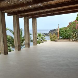 Outdoor terrace with seamless Microcement Diamond Floor System by Decora overlooking the coast
