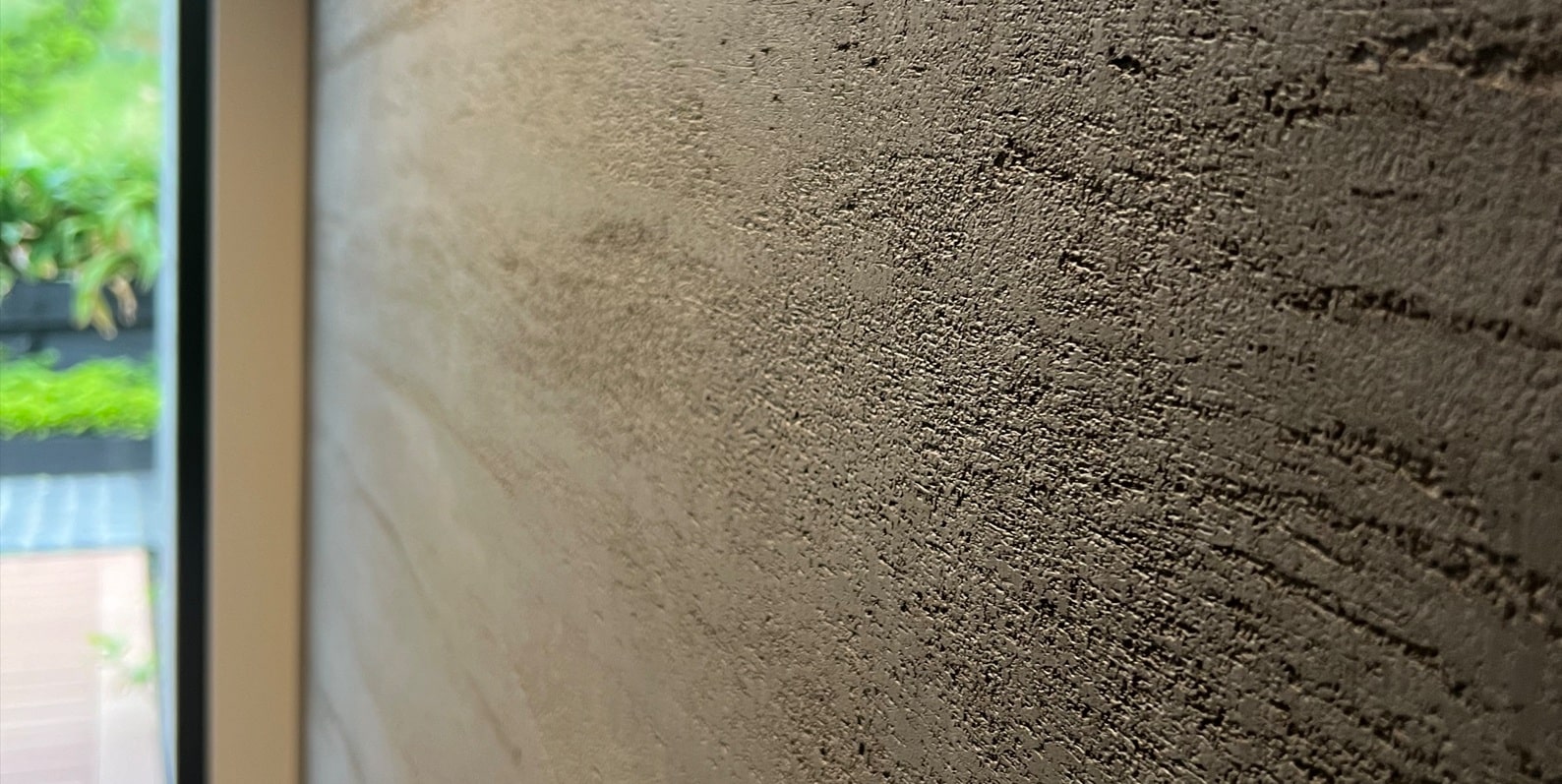 Close-up of a textured Teseo lime wall finish in warm beige tones, by Decora A&C.
