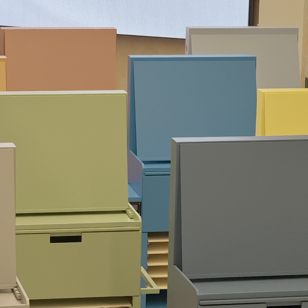 Colorful storage units in an artfully arranged workspace, showcasing pre-finish surfaces before applying Decora A&C's luxury Italian wall textures.