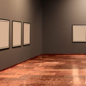 Modern art gallery with empty frames on dark gray walls.
