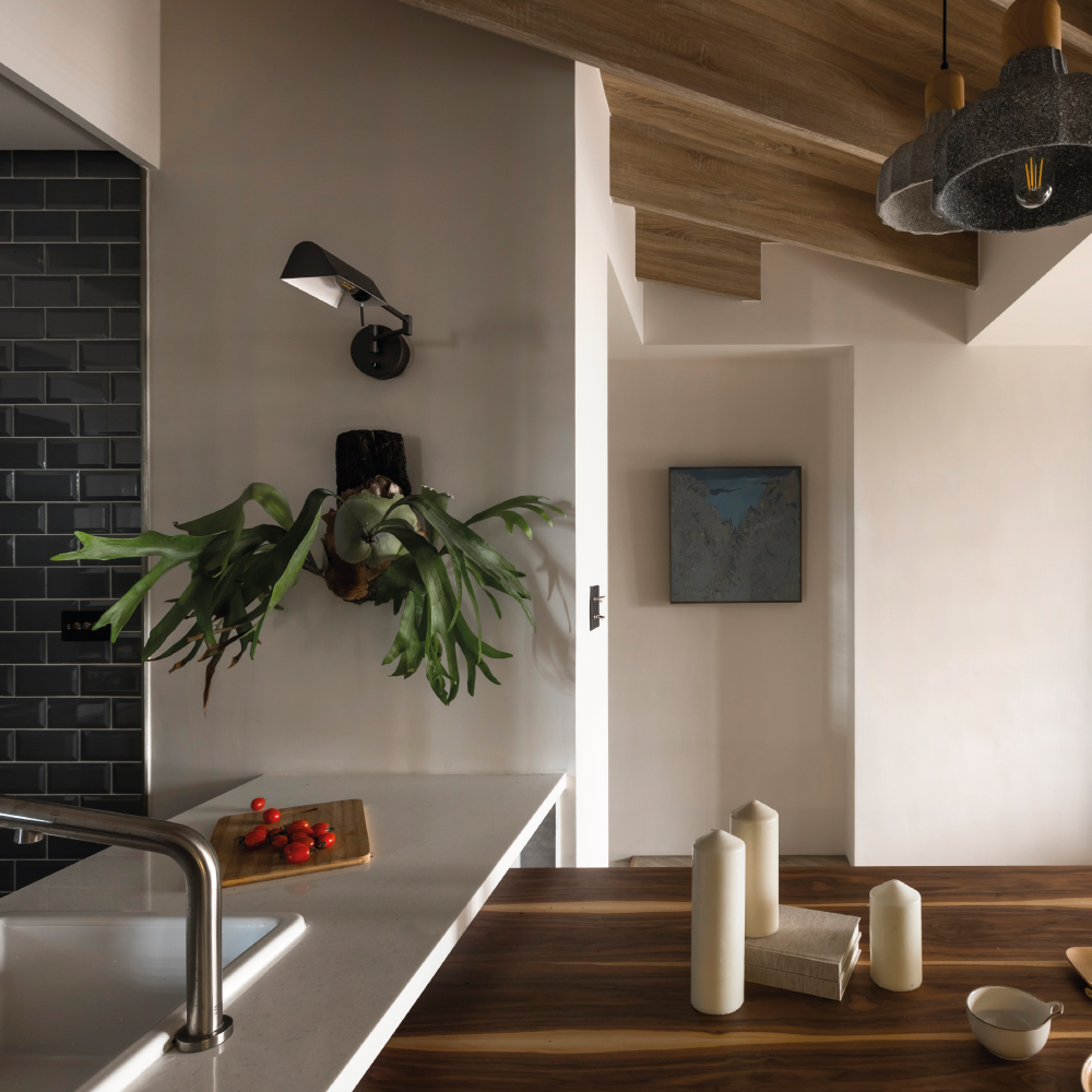 Modern kitchen and dining space featuring walls finished with Decora A&C Unica Single Coat Low VOC Water-Based Paint, complemented by natural wood accents.